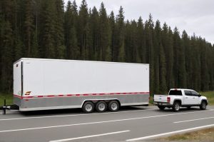 Photo of a 24 foot cargo trailer being towed by a pickup truck.